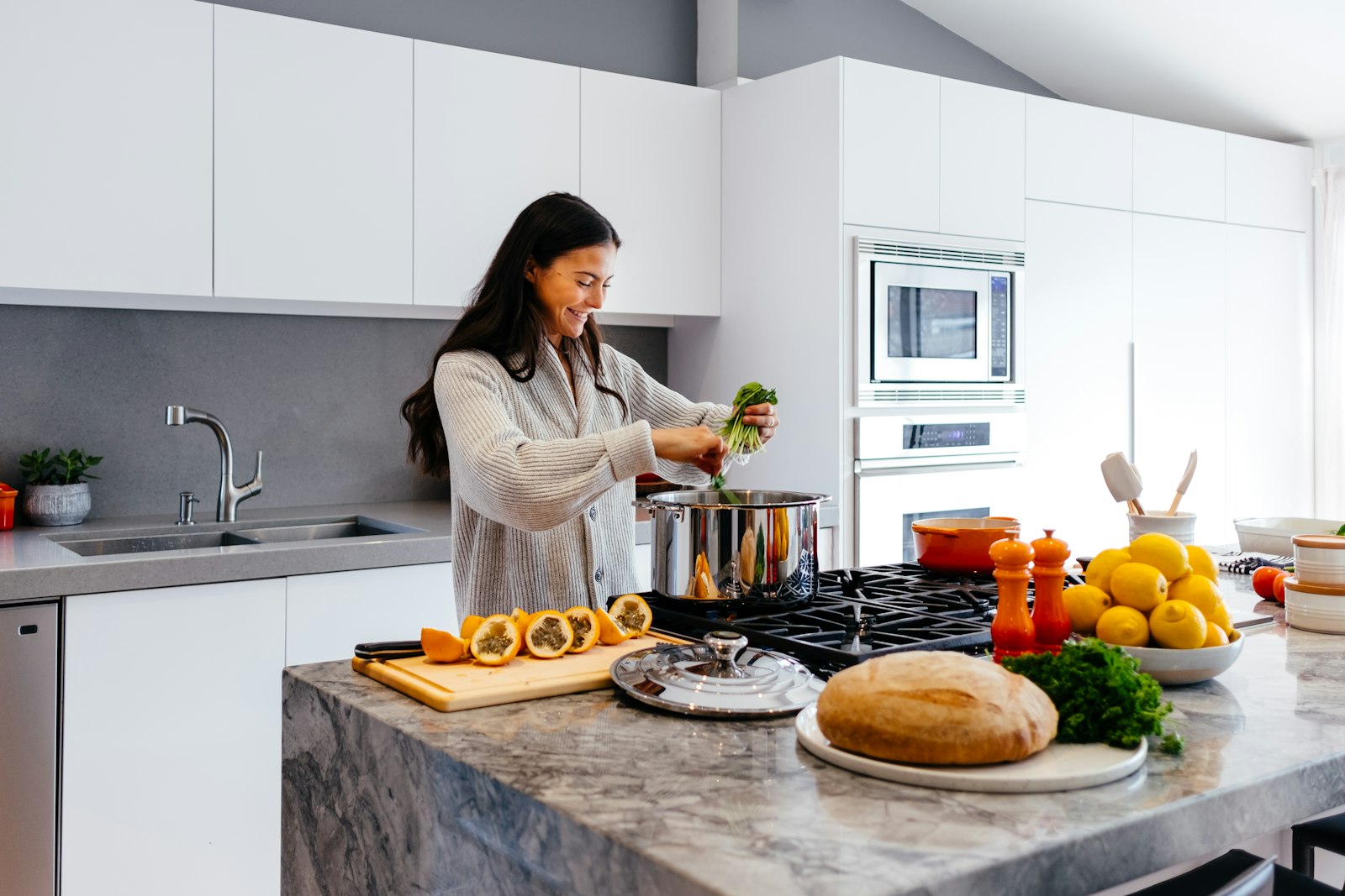 Woman smiling while cooking a healthy meal